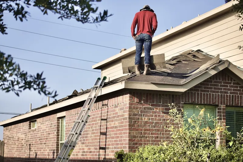 Professional roofer working on a residential roof in Stonebridge